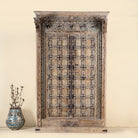 Decorative wooden cabinet with intricate patterns on a beige background