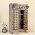 Open Door picture of a one-of-a-kind Indian cabinet made from an old door, featuring intricate hand carvings and traditional craftsmanship in a vintage finish.
