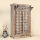 One-of-a-kind Indian cabinet made from an old door, featuring intricate hand carvings and traditional craftsmanship in a vintage finish.