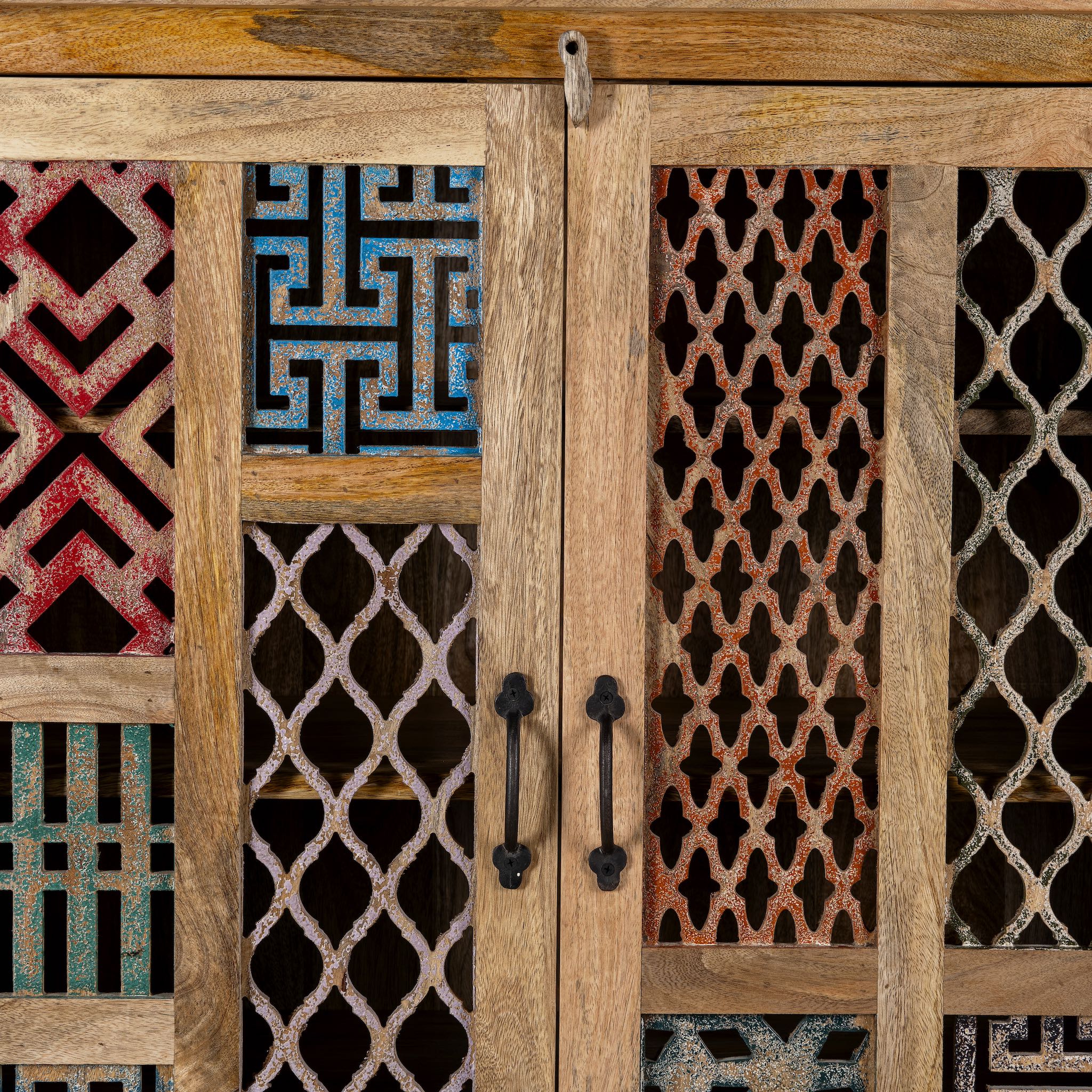 Close up image of a artisan-made cabinet crafted from mango wood, featuring double doors adorned with a patchwork of colourful, intricately carved geometric panels, blending traditional craftsmanship with a vibrant, eclectic style.
