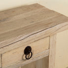 Close up image of a Ibiza style reclaimed teak console table with sandblasted finish, three drawers, and lower shelf, versatile as bathroom furniture or hallway console.