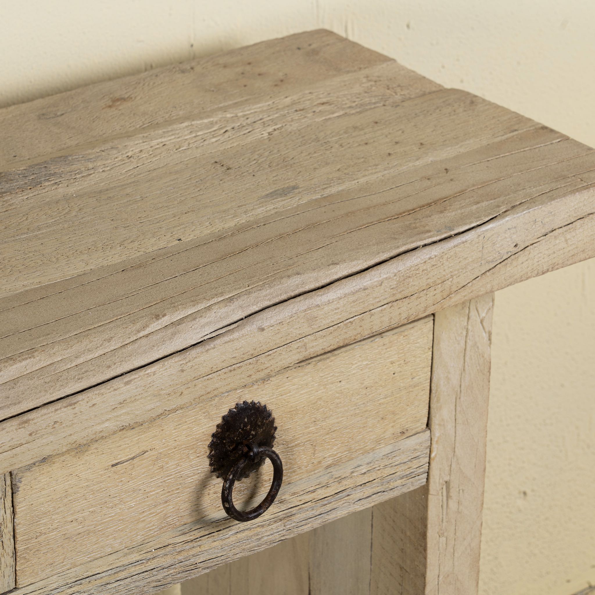 Close up image of a Ibiza style reclaimed teak console table with sandblasted finish, three drawers, and lower shelf, versatile as bathroom furniture or hallway console.
