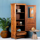Side angle image with open door of a antique teak wood display cabinet with glass door, shelves, and lower drawer – unique furniture piece crafted from teak wood with traditional Indian design and honey wax finish.