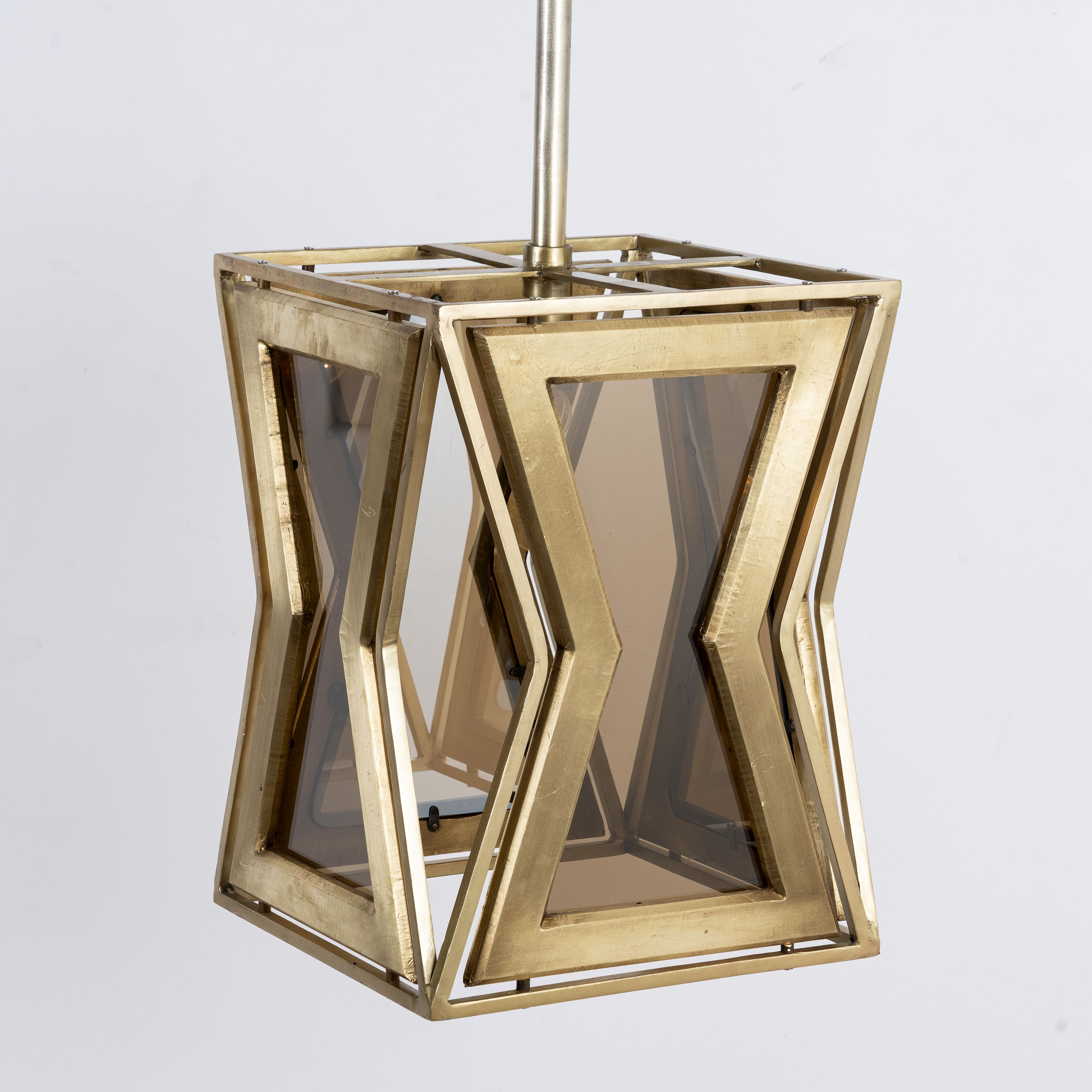 Side angle image of a Tapered pendant lamp with wood, brass cladding, and tinted glass panels – vintage lighting meets modern design, ideal for use as an iron pendant lamp in living rooms, dining areas, or entryways.