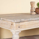 Close up image of a sandblasted reclaimed wood dining table with carved legs, sustainable dining room furniture, 220×100×75 cm.