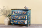 Side angle image with open drawers of a hand-painted cupboard made of reclaimed wood with floral drawer fronts – Divisha model by Om Home & Garden