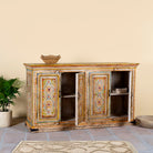 Ope door image of a hand-painted reclaimed wood sideboard with floral motifs, a bold piece of vintage furniture for living room furniture collections.