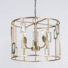 Side angle image of a unique pendant light with round shiny brass-plated frame and magnifying glass inserts – vintage lighting with three-light design for dining rooms, kitchens, or elegant interiors.