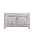 White background picture of a Ibiza style sideboard with six drawers, made from hand-carved wood in a whitewashed finish, featuring circular mandala motifs and rustic iron handles.