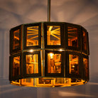 Image with lighted octagon-shaped wooden pendant lamp with antique brass accents – handcrafted wooden lamp for industrial style lighting in dining or living spaces.