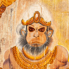 Close up image of a hand-painted vintage door panel measuring 54x3x195 cm, depicting the powerful figure of Lord Hanuman holding a golden mace, adorned in traditional attire with intricate jewelry, set against a distressed wooden background for an aged, sacred appearance.
