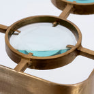 Close up image of a unique pendant light with square brass-plated iron frame and magnifying blue and white glass inserts – a vintage lighting piece for kitchens, dining rooms, or living areas.