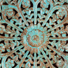 Close up image of a hand-carved mango wood wall panel with floral motifs in blue finish – Kataee Blue model by Om Home & Garden