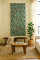 Lifestyle scene with a hand-carved mango wood wall panel with floral motifs in blue finish – Kataee Blue model by Om Home & Garden