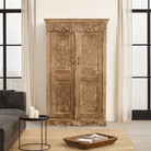 Lifestyle scene with a hand-carved reclaimed wood wardrobe with vintage finish – a sustainable furniture piece ideal for Indian home decor and rustic interiors.