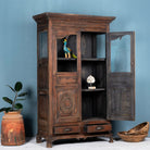 Side angle image with open doors of a reclaimed teak wood display cabinet with glass doors – unique Indian furniture with natural wax finish and timeless craftsmanship.