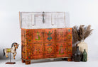Image with open lid of a recycled teak wood chest with hand-painted Indian motifs in orange – sustainable furniture with vibrant character and cultural craftsmanship.