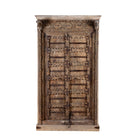 Vintage wooden wardrobe with intricate carvings on a white background