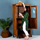 Tall reclaimed teak wood display cabinet with two glass doors and a bottom drawer – wooden display cabinet crafted as sustainable furniture with natural elegance.