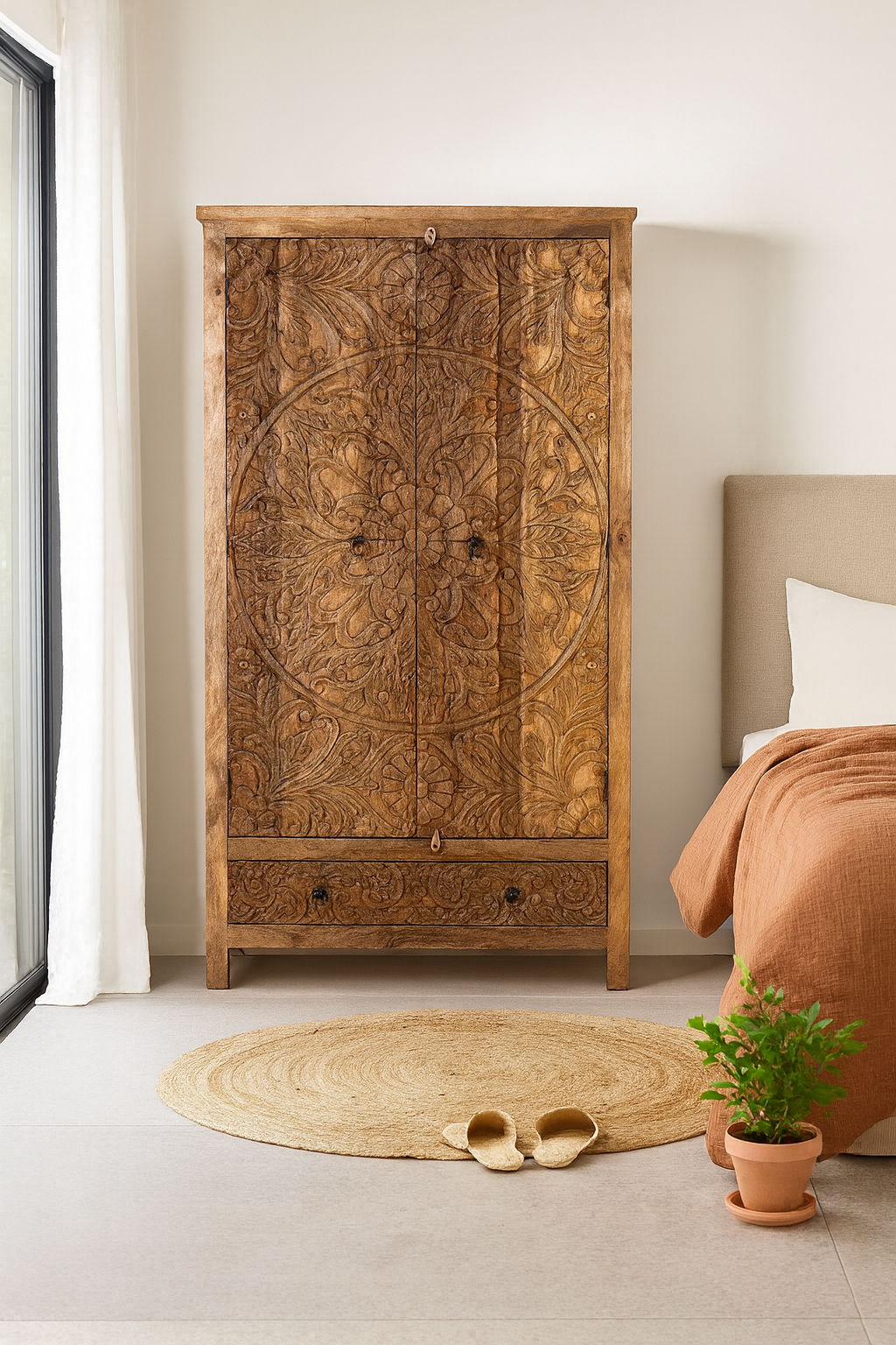 Lifestyle image of a mango wood wardrobe with hand-carved floral detailing, Indian carved wooden furniture with bottom drawer, 105 × 40 × 180 cm.