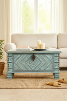 Lifestyle image of a blue hand-carved mango wood chest with floral and geometric carvings – wood chest box perfect for boho style storage or decorative accent.