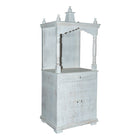 Side angle image of a Shivani mango wood house temple in whitewashed finish with carved floral doors and traditional arched canopy—an elegant example of hand-carved Mandirs and Indian home temples.