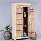 Open door image of a rustic solid wood wardrobe featuring vintage reclaimed door panels with iron accents and ring pull handles.