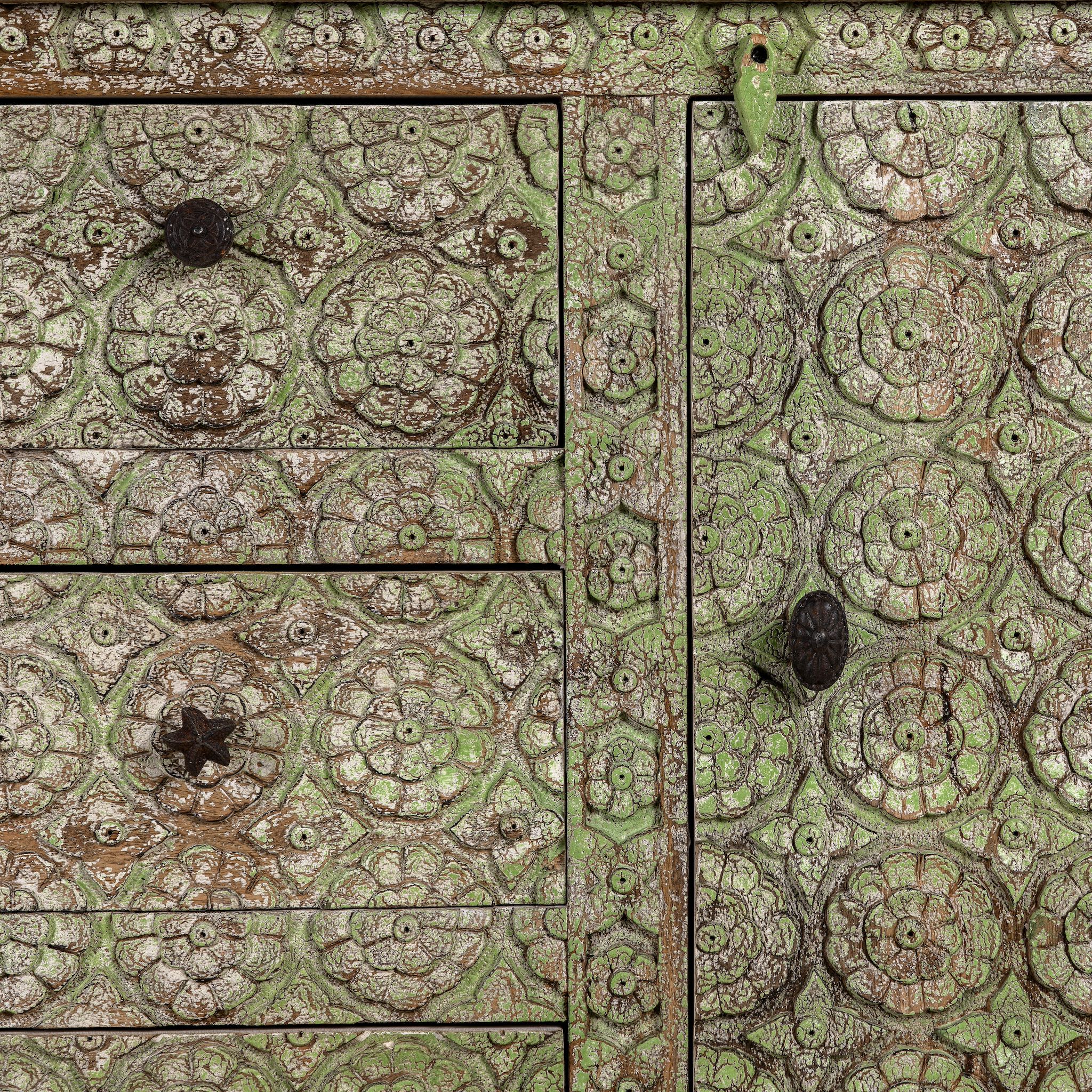 Close up picture of a carved wooden furniture sideboard with floral hand-carving and distressed finish, vintage style cabinet made from mango wood, 150 × 40 × 90 cm.