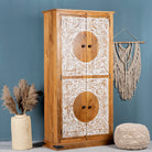 Side angle image of a mango wood furniture cabinet with full front floral carving, artisanal bedroom furniture with hand-carved details, 180 × 90 × 40 cm.