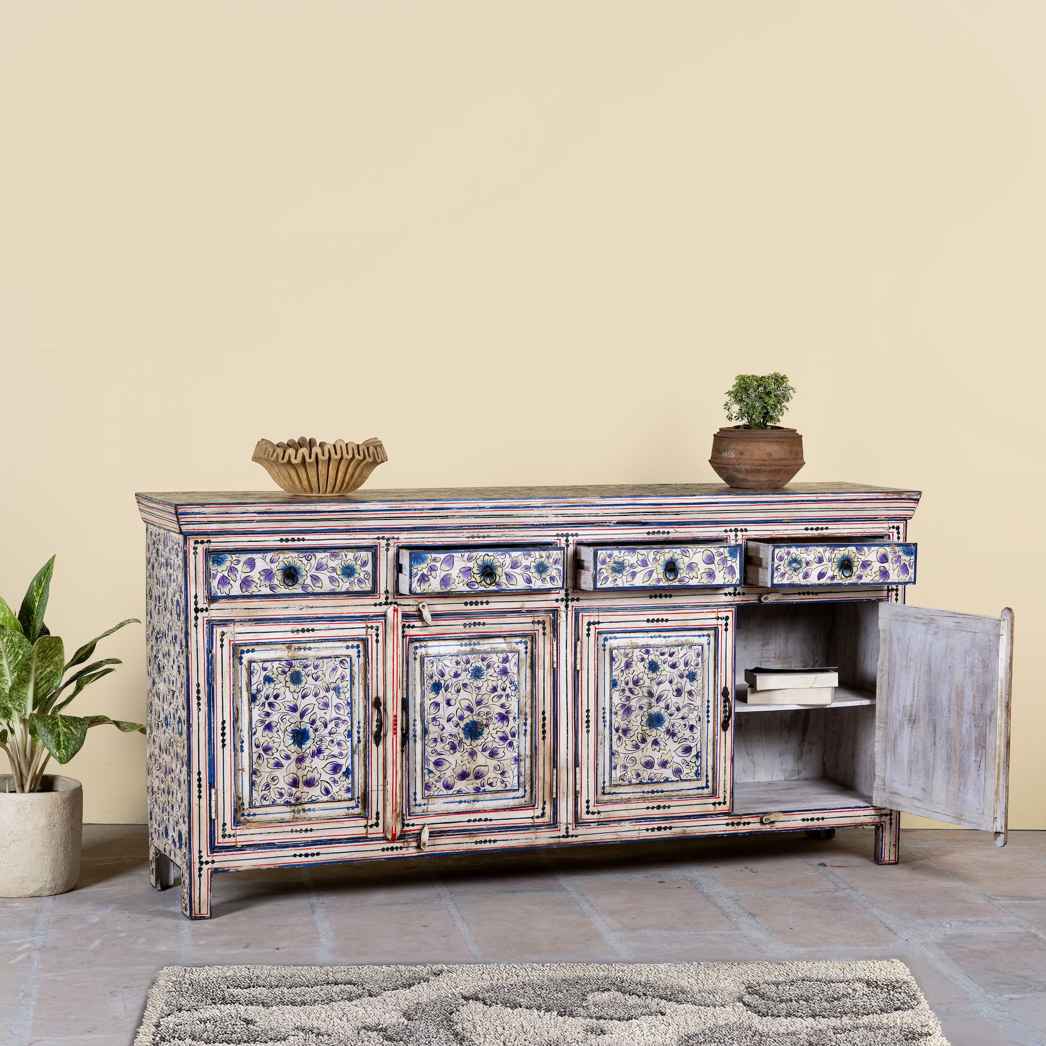 Open door image of a hand painted sideboard in reclaimed wood, an artisanal furniture piece with floral motifs and multicolour finish.