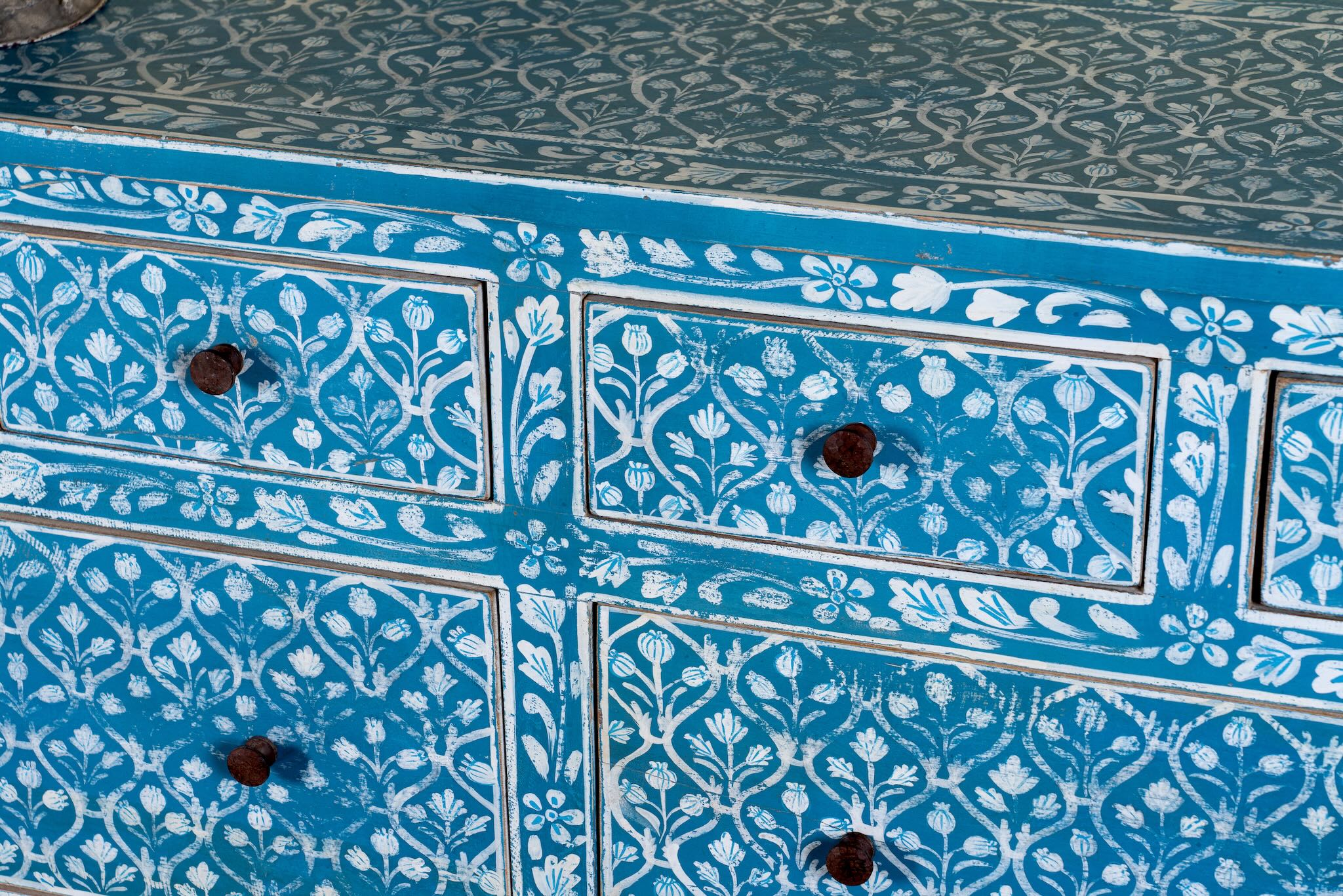 Close up image of a hand-painted chest of drawers made of reclaimed wood in blue and white – Nitara model by Om Home & Garden