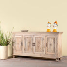 Side angle image of a hand-carved mango wood sideboard with sandblasted finish – a rustic mango wood furniture piece ideal for Ibiza style interiors.