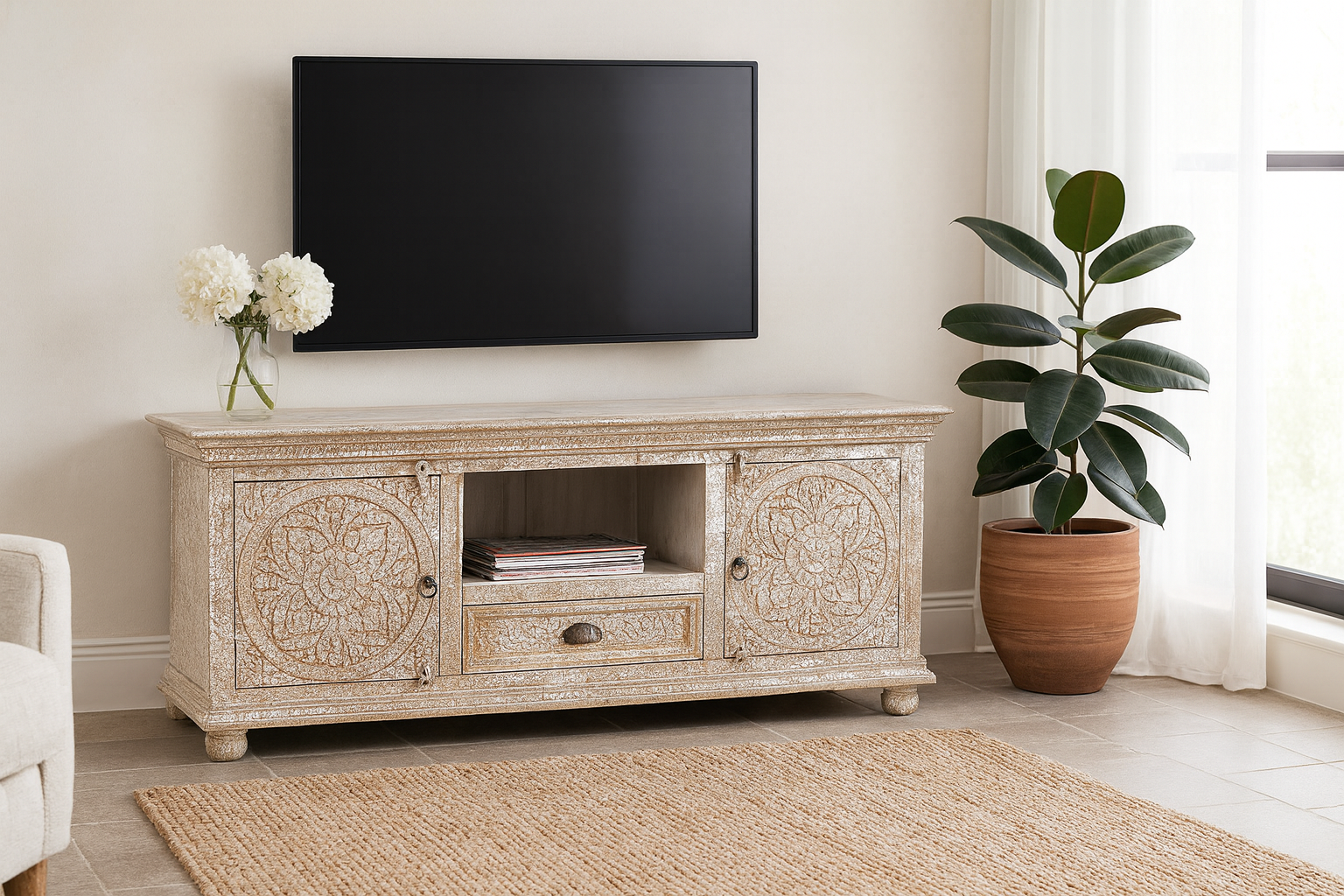 Lifestyle imagination of a carved mango wood lowboard with floral doors, crackled vintage finish, drawer, and open shelf, 150 × 40 × 64 cm.