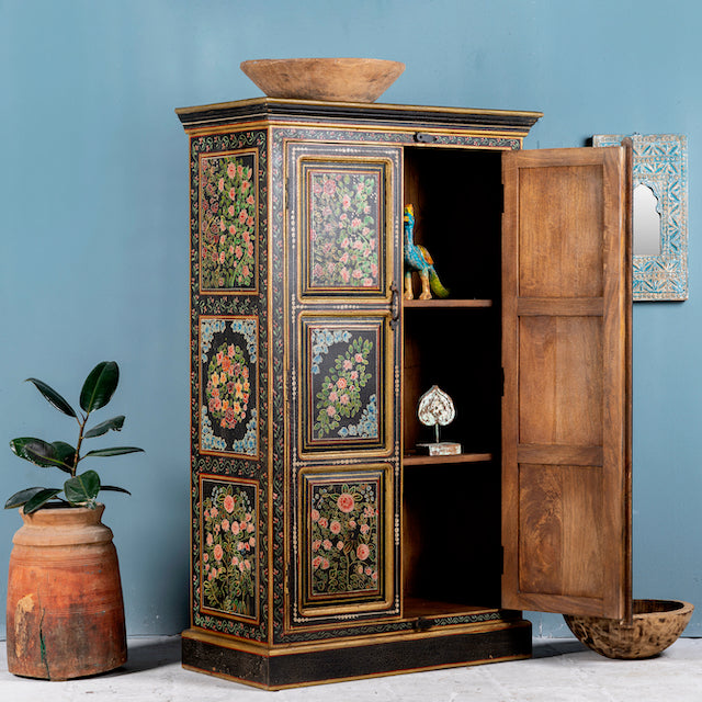 Side angle image with open door of a hand-painted cabinet made from recycled wood with floral motifs – sustainable furniture and unique furniture for bold, artistic interiors.