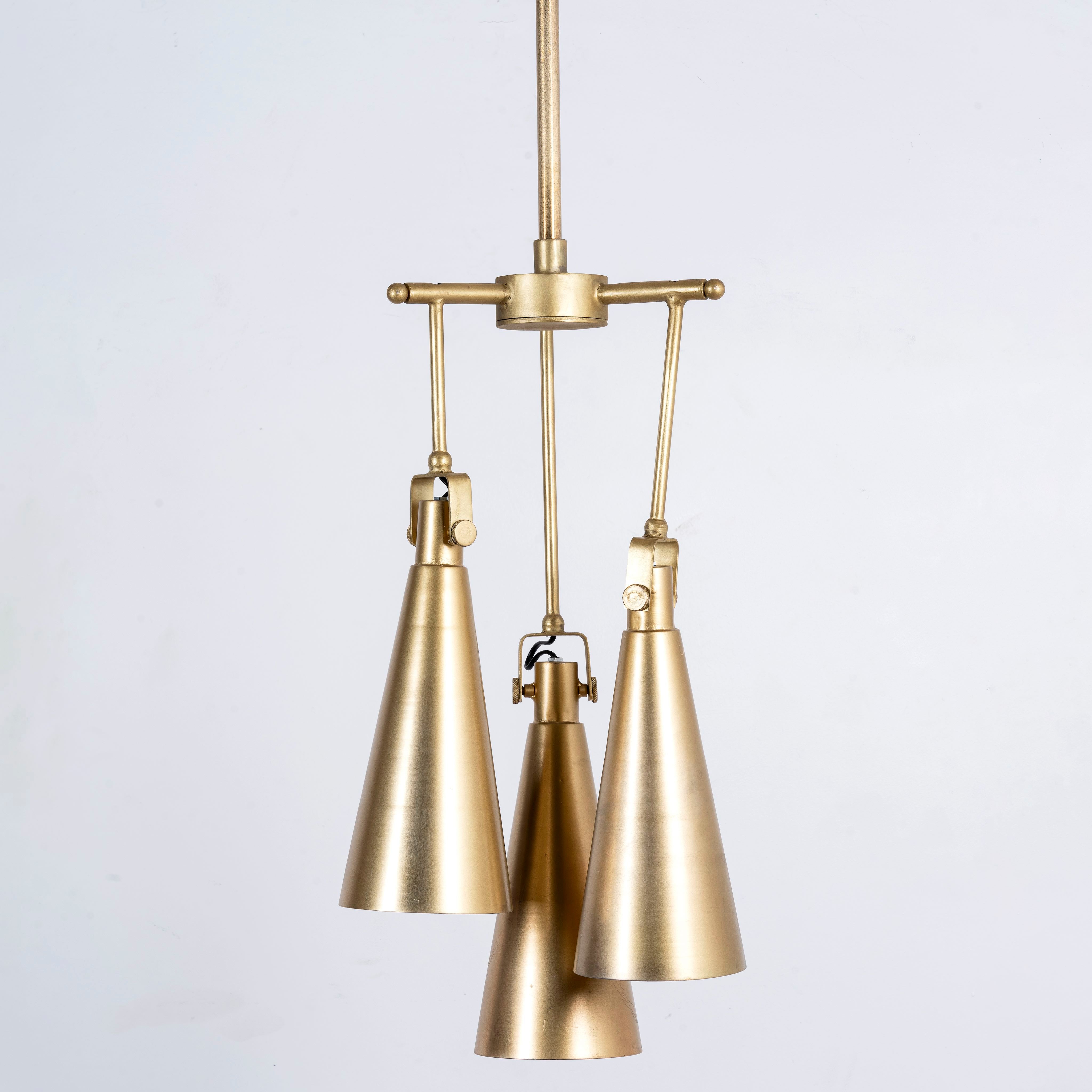 Polished brass iron pendant lamp with sleek tapered shape – minimalistic style lighting fixture with three lights for kitchens, dining rooms, or entryways.