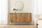Lifestyle imagination of a handmade mango wood sideboard with live-edge design, brass-coated base, and handles—an artisanal furniture piece combining natural and modern elements.