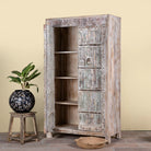 Side angle image with open door of a reclaimed wood wardrobe made with antique door panels – a handcrafted piece of old door furniture perfect for Indian home decor and rustic interiors.