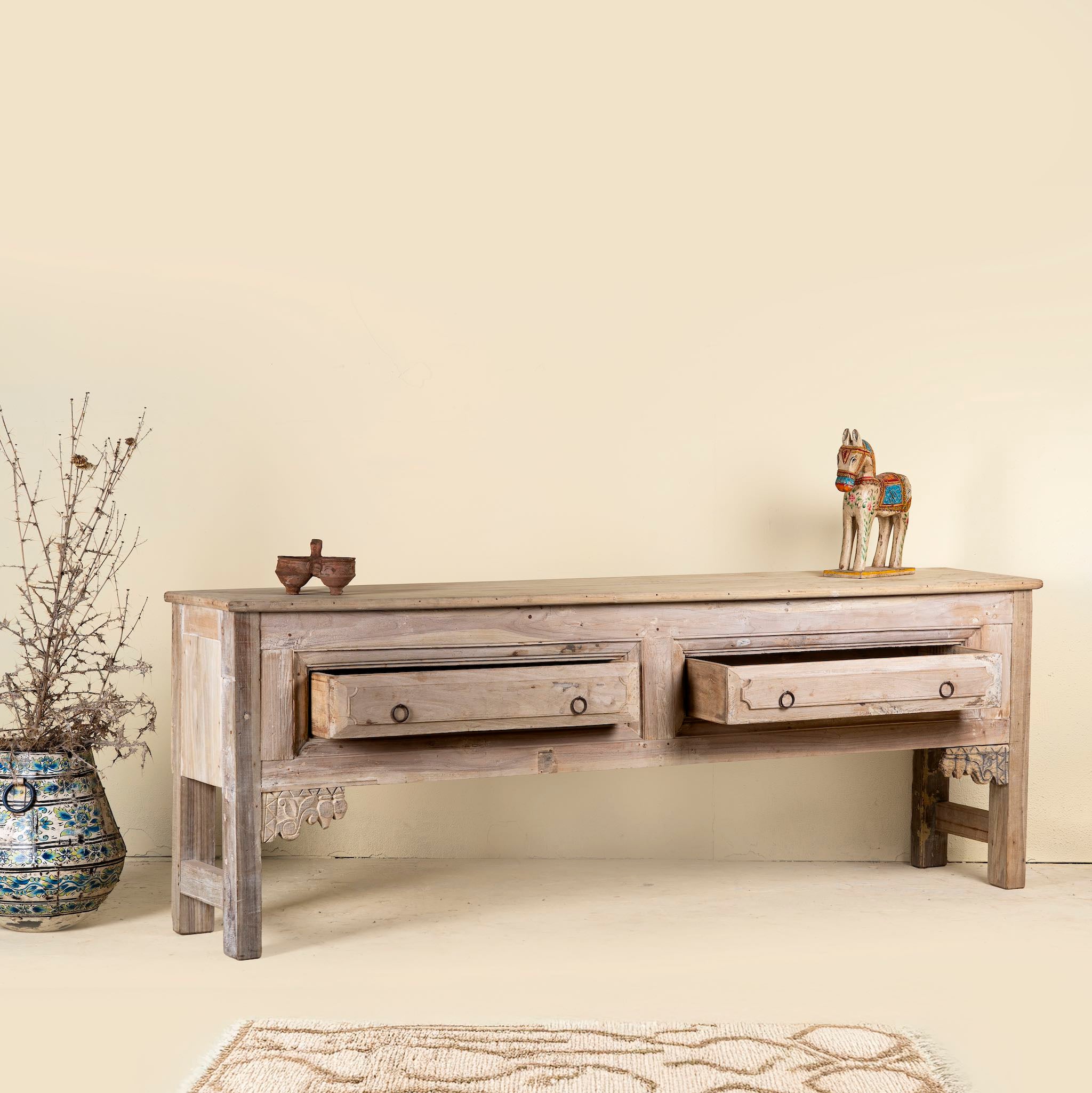 Open drawer image of a carved console table made from reclaimed teak, a refined example of unique wooden furniture.