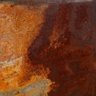 Close-up of a rusted iron and teak wall panel, artisanal furniture piece, part of our Indian home decor collection.