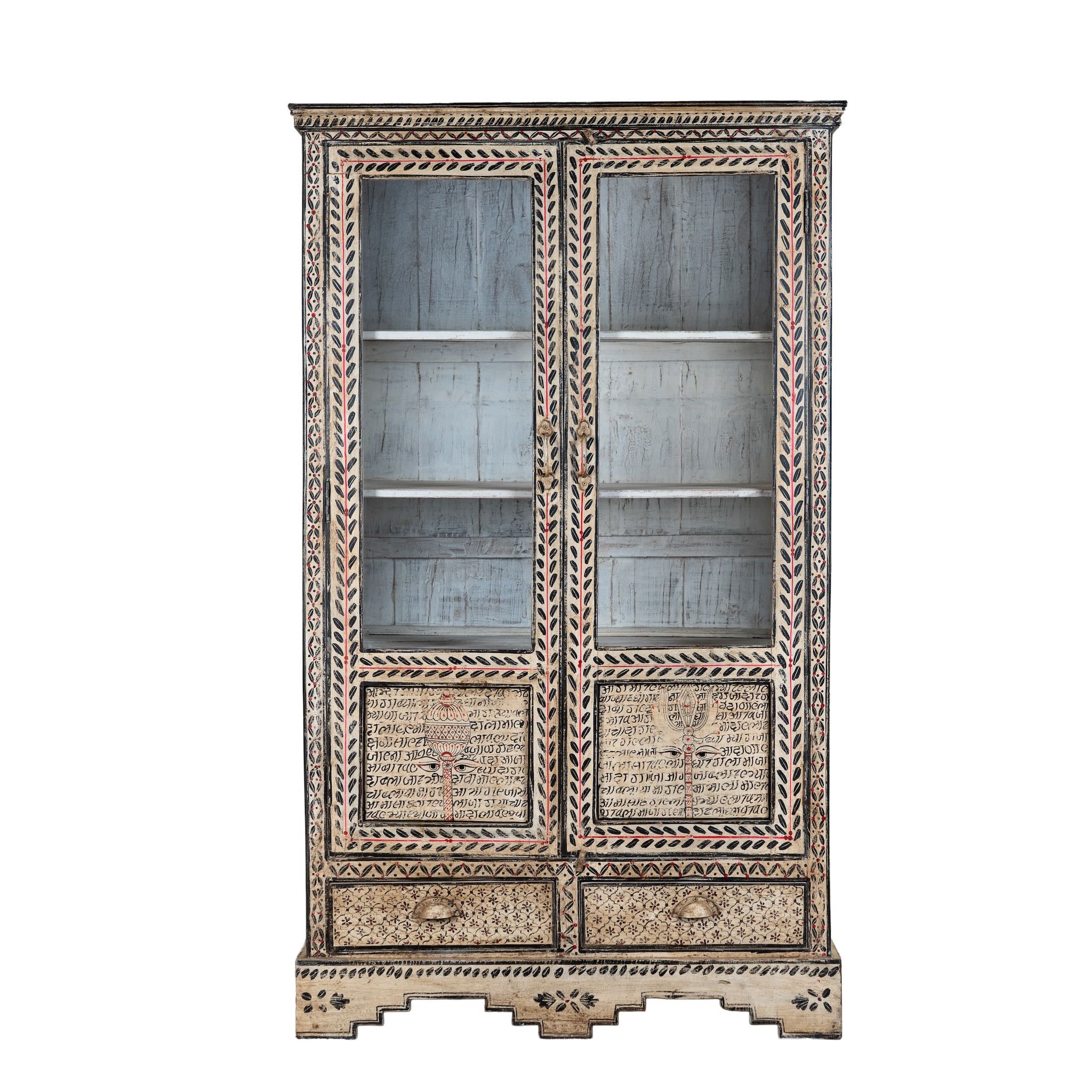 White background image of a hand-painted display cabinet made from recycled wood with glass doors – sustainable furniture featuring Sanskrit motifs and traditional Indian craftsmanship.