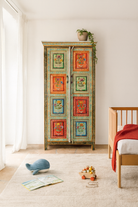 Lifestyle image of a hand-painted sustainable teak wood cabinet with floral motifs – Sangrur by Om Home & Garden, a one-of-a-kind piece of sustainable furniture with artistic expression.