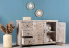 Side angle image with open door of a hand‑carved vintage style mango wood sideboard with distressed floral lattice panels, 150 × 40 × 90 cm.