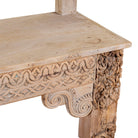 Close up image of a Shraddha bench made from bleached reclaimed teak wood with intricate hand-carved floral details, showcasing traditional Indian craftsmanship and sustainable furniture design.