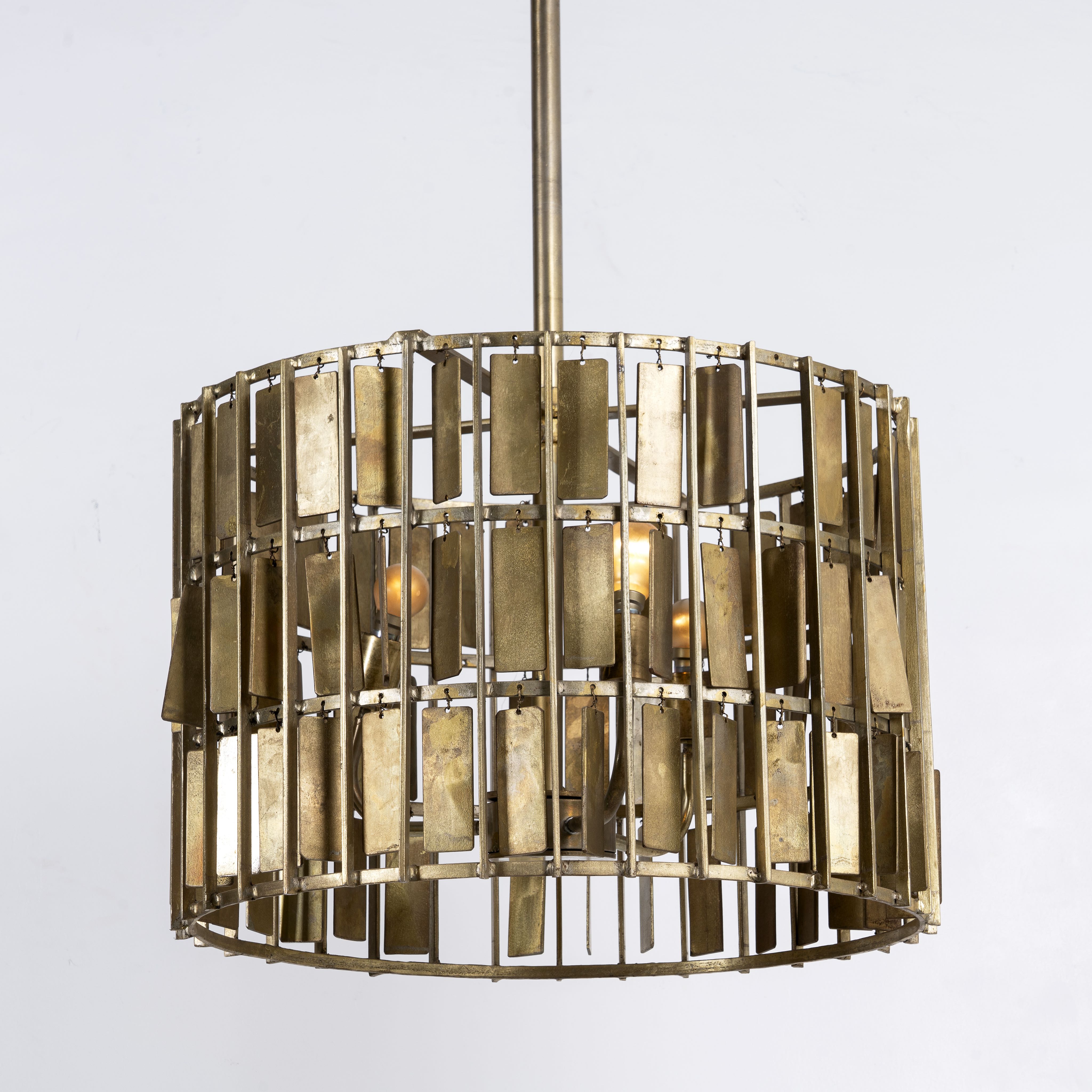 Large round brass-plated iron pendant lamp with ornate tile surface – vintage lighting and iron pendant light ideal for dining rooms or living spaces.