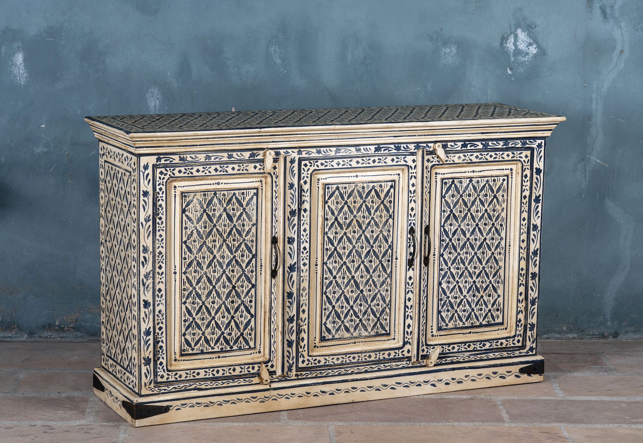 Side angle image of a hand-painted sideboard made from reclaimed wood in indigo and cream tones – a handcrafted piece of reclaimed wood furniture perfect for hand painted interiors.