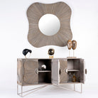 Side angle image with open door of a handcrafted mango wood sideboard with floral-inspired sunburst carving, grey wash finish, and silver accents – mid century style furniture for elegant living spaces.