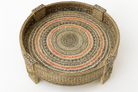 Close up image of a reclaimed wood coffee table made from antique teak oil press with hand-painted Sanskrit symbols and glass top; hand painted coffee table, 75 cm diameter, 25 cm height.