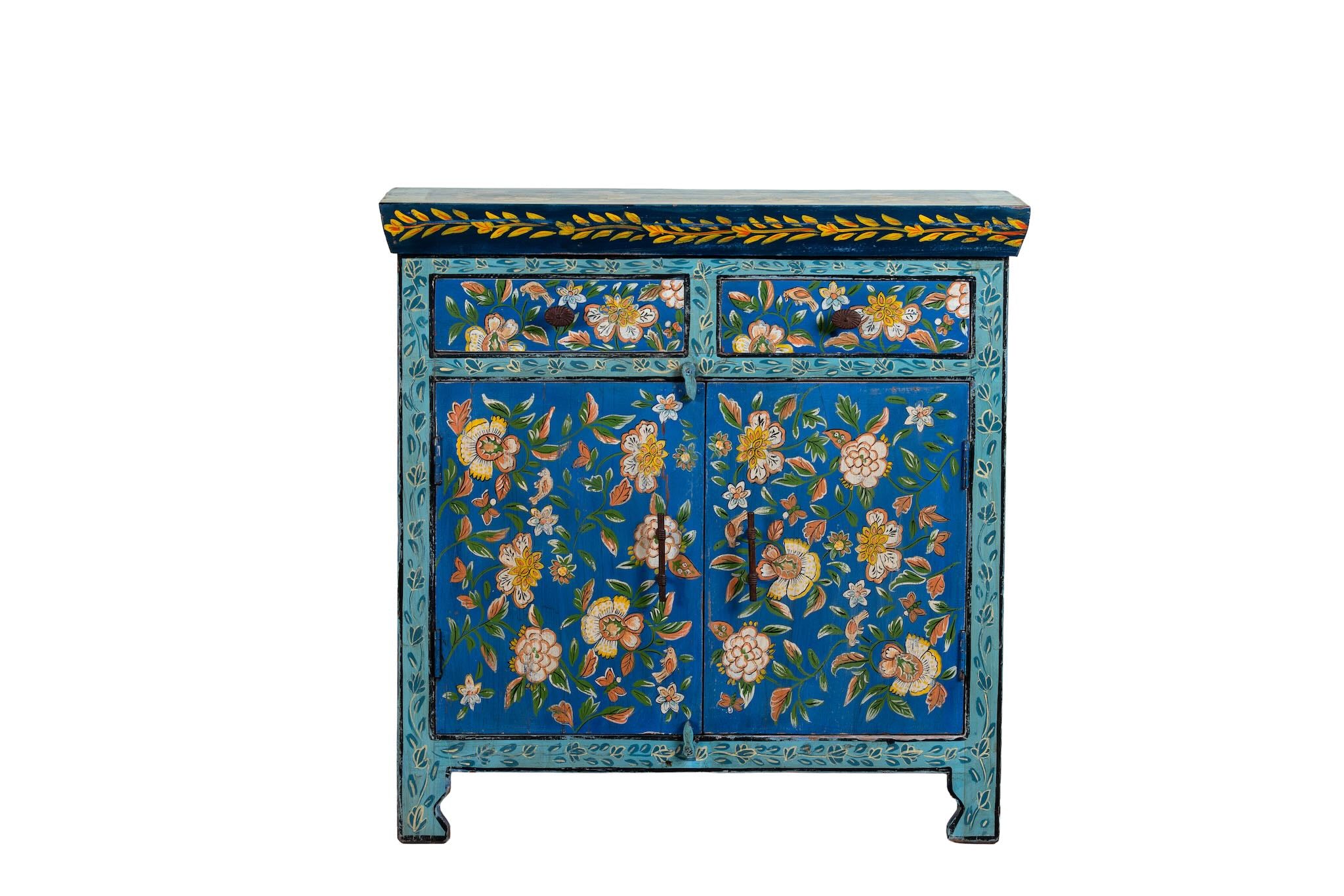 White background image of a hand-painted cupboard made of reclaimed wood with vibrant floral design – Tvesa model by Om Home & Garden
