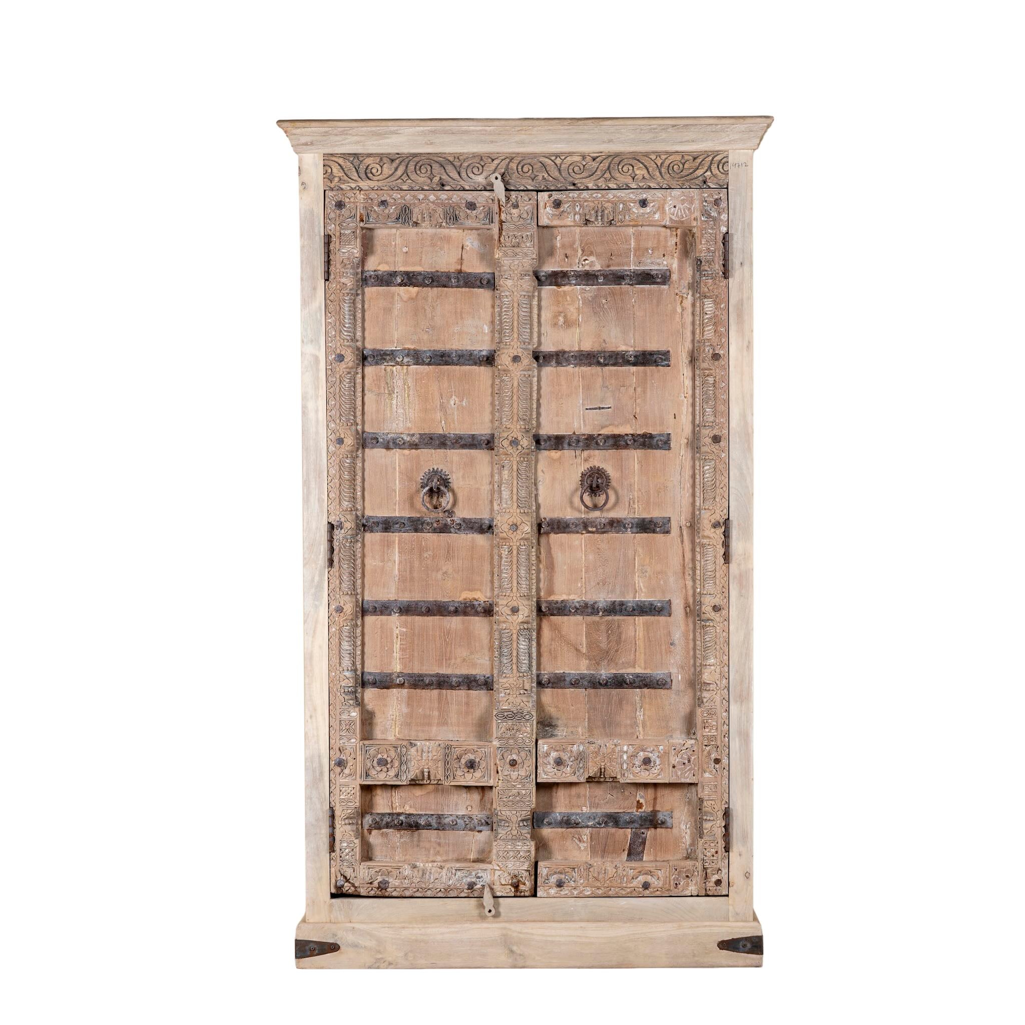 White background image of a hand-carved teak wood wardrobe with original iron fittings – Veena model by Om Home & Garden