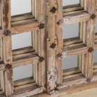 Close up of a wooden door mirror with antique teak frame and carvings, part of our Indian home decor collection.